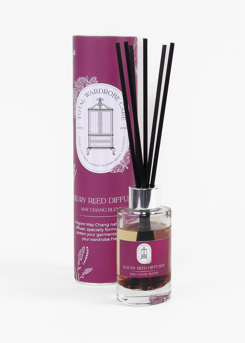Reed diffuser with burgundy packaging on a white background