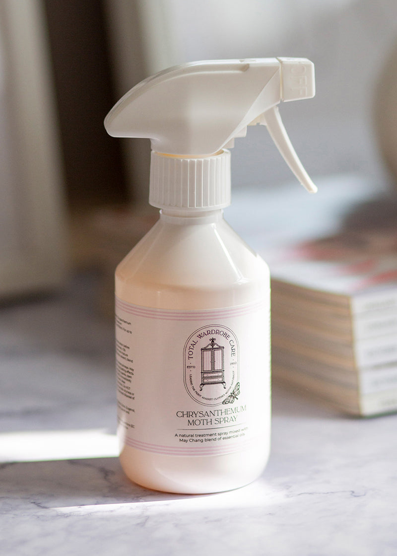 Chryssanthemum moth killer bottle with trigger spray on a light surface