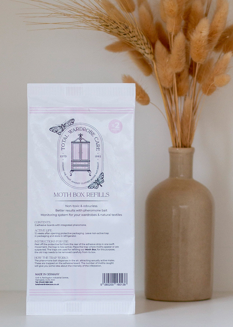 Clothes Moth box refills pack with a vase of dried grasses on a neutral background
