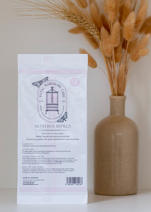 Clothes Moth box refills pack with a vase of dried grasses on a neutral background