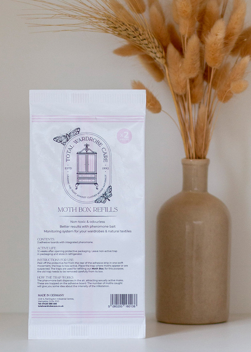 Clothes Moth box refills pack with a vase of dried grasses on a neutral background
