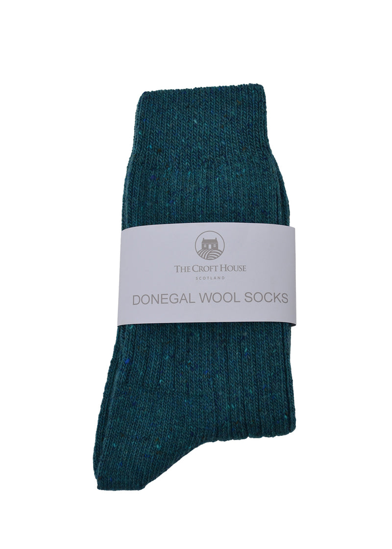 Teal donegal wool socks folded with a white label on a white background