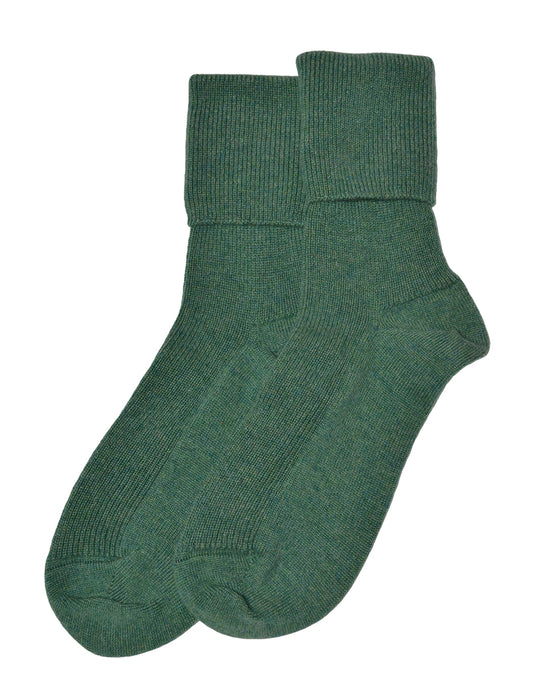 Pair of jade green socks on a white background
