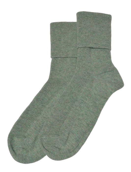 Pair of pastel mint green socks on a white background