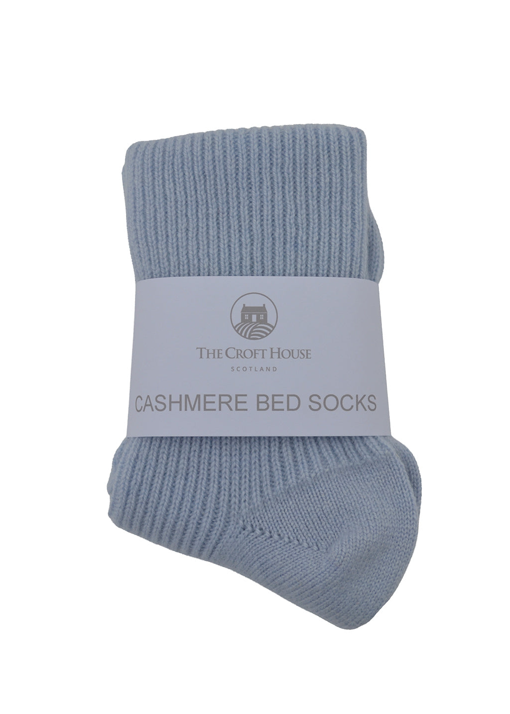 A pair of light blue ribbed cashmere bed socks folded together with a white paper label band that reads 'THE CROFT HOUSE SCOTLAND' and 'CASHMERE BED SOCKS'.