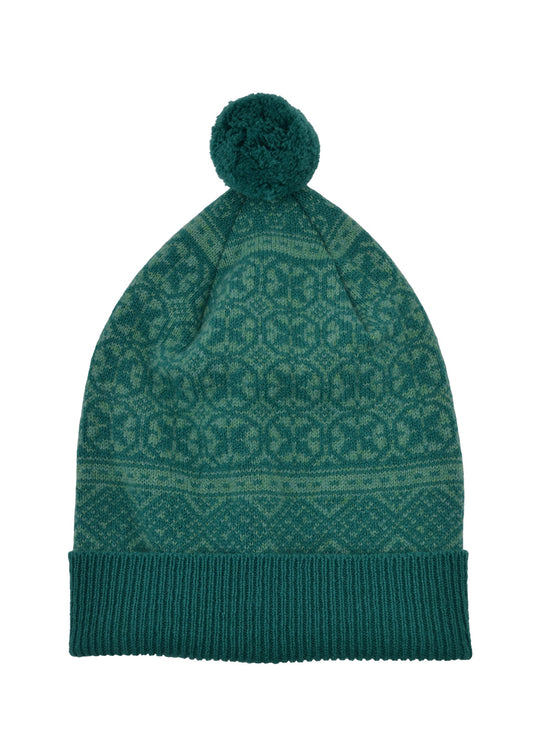 A sea green knit beanie hat with a matching pom-pom on top, featuring a Fair Isle pattern and a ribbed cuff, shown against a plain white background.